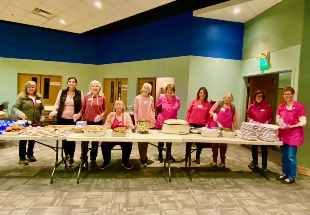 SYNC Volunteers serving dinner at a Pathfinders Children's Ministry Meeting