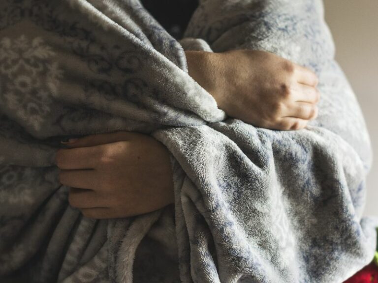 Child snuggling in a warm blanket