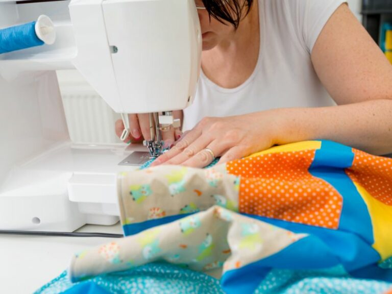 Woman machine quilting a quilt for a child